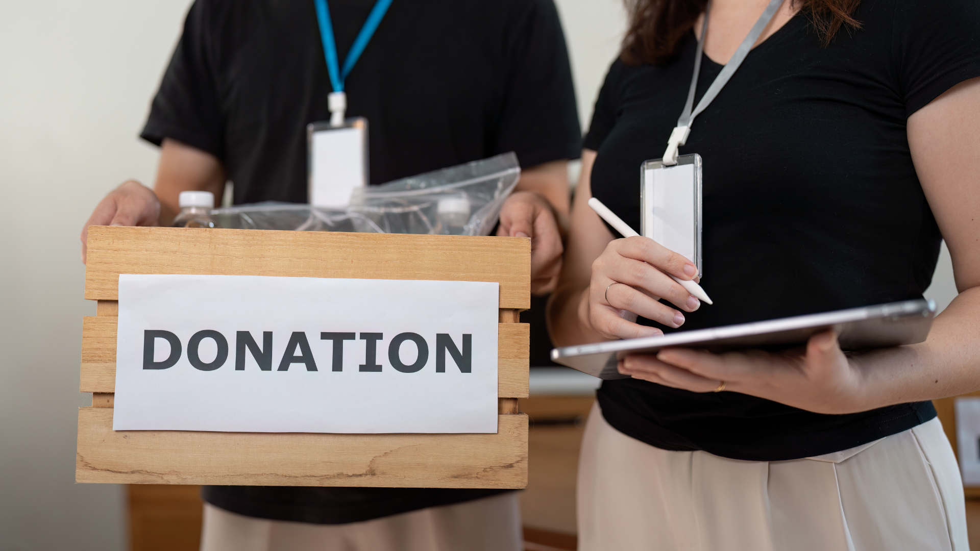 An image of two Etobicoke business owners providing Charitable Donations to a local non for profit