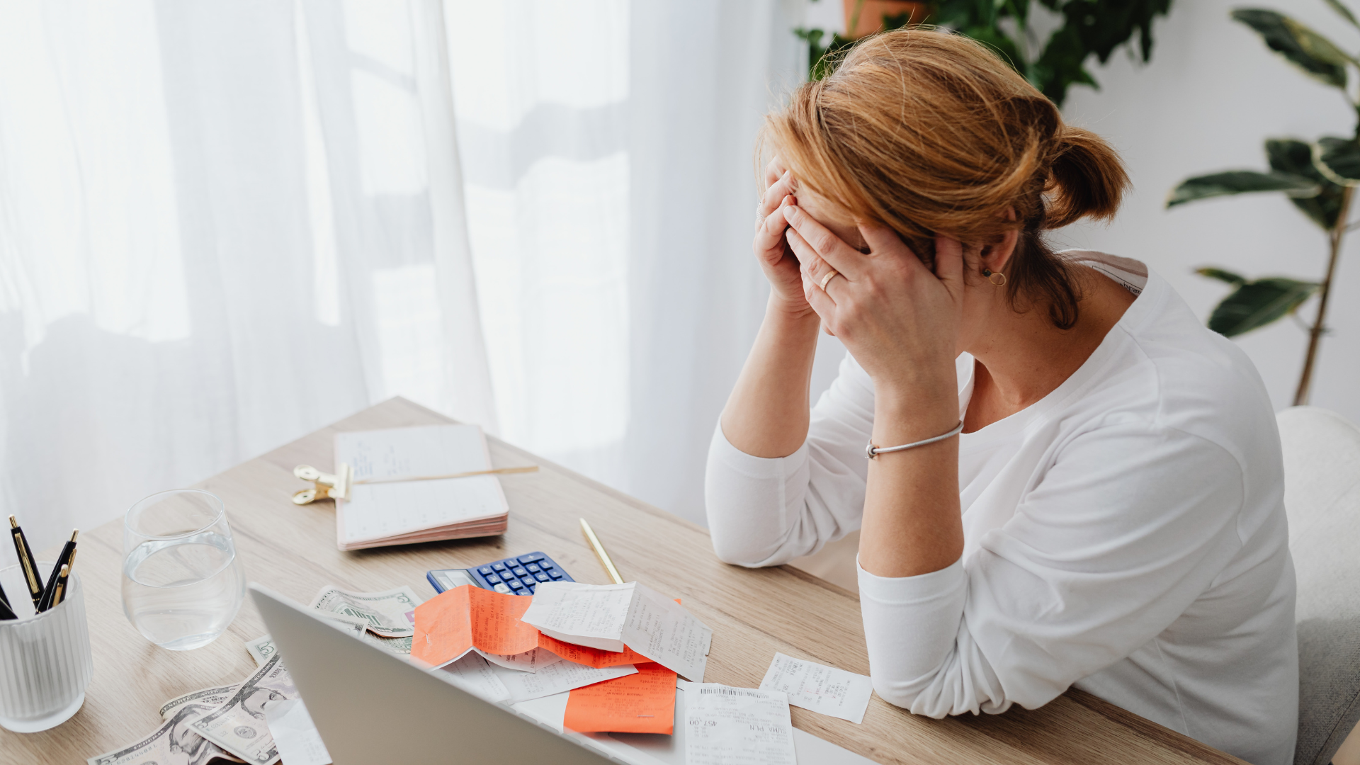 An image of a small business owner in Etobicoke who is stressed over managing her debt repayment