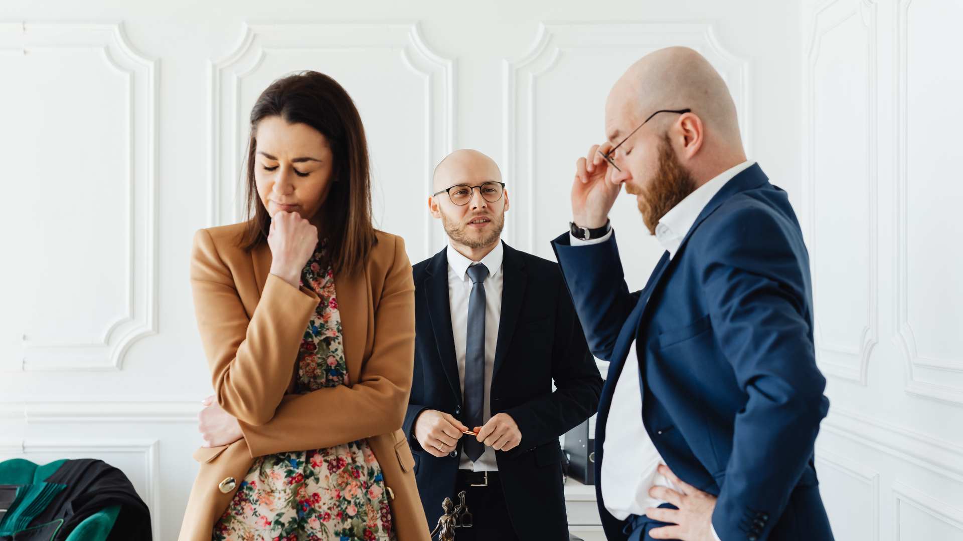 An image of a couple who are meeting with their lawyer while going through a divorce.